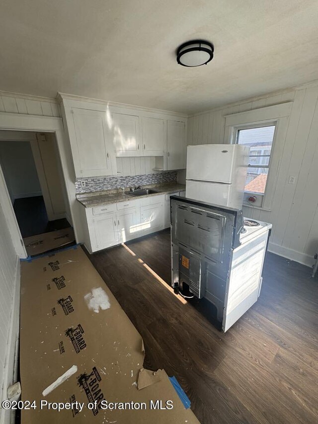 kitchen with white cabinets, backsplash, sink, and dark wood-type flooring