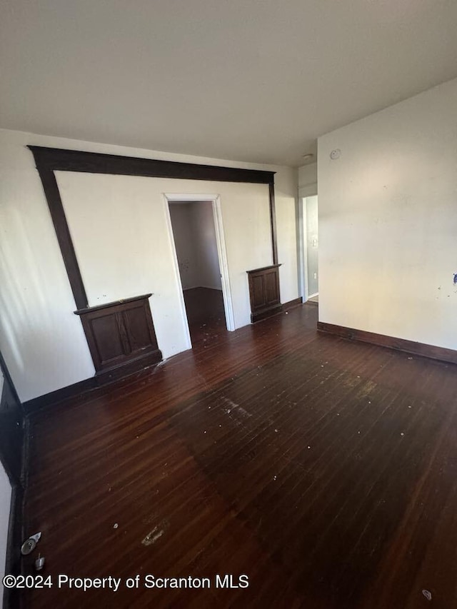 empty room with dark wood-type flooring