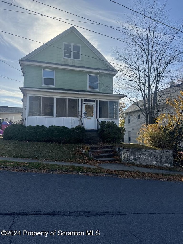 view of front of house with a sunroom