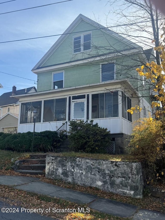 view of front facade with a sunroom