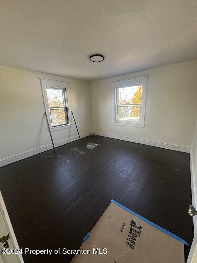 spare room featuring dark hardwood / wood-style flooring