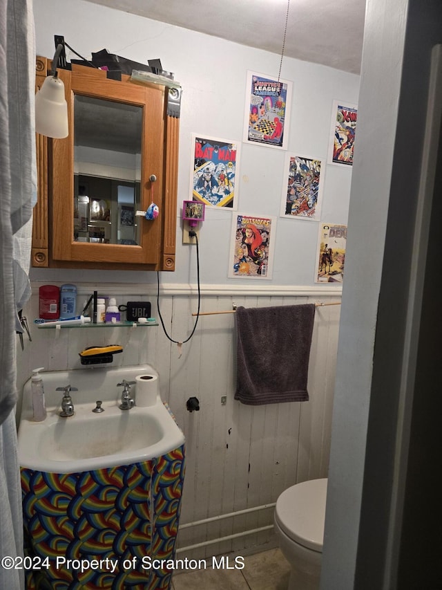 bathroom with tile patterned flooring, toilet, and sink