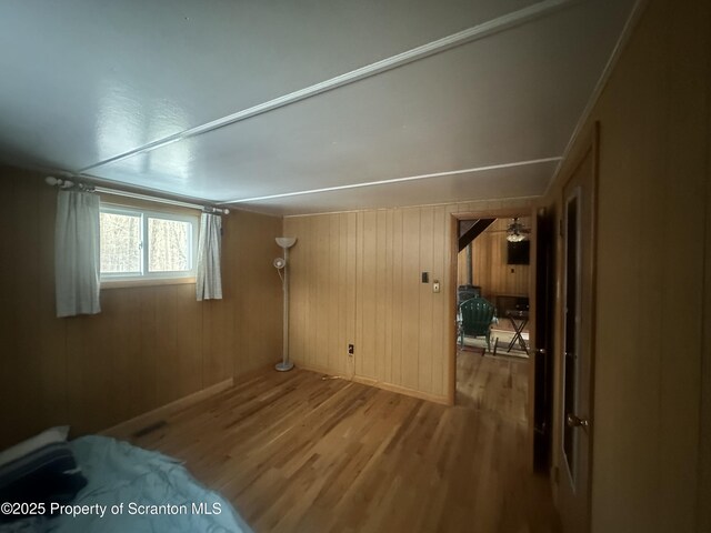 105 Hughes Dr, Greene Twp, PA 18426 - empty room with wood finished floors and wooden walls