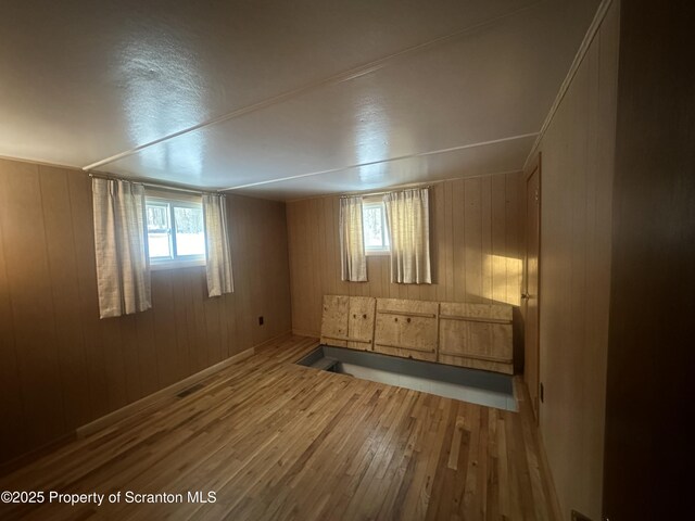 105 Hughes Dr, Greene Twp, PA 18426 - empty room featuring wood finished floors, healthy amount of natural light, and wood walls