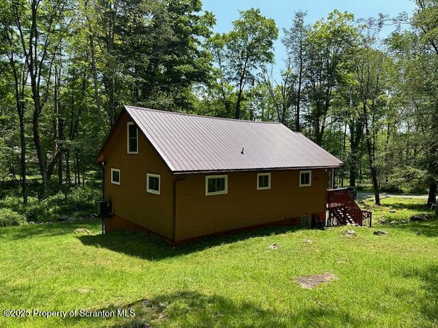105 Hughes Dr, Greene Twp, PA 18426 - view of property exterior with a yard and a metal roof
