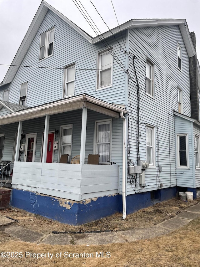 view of side of property with a porch