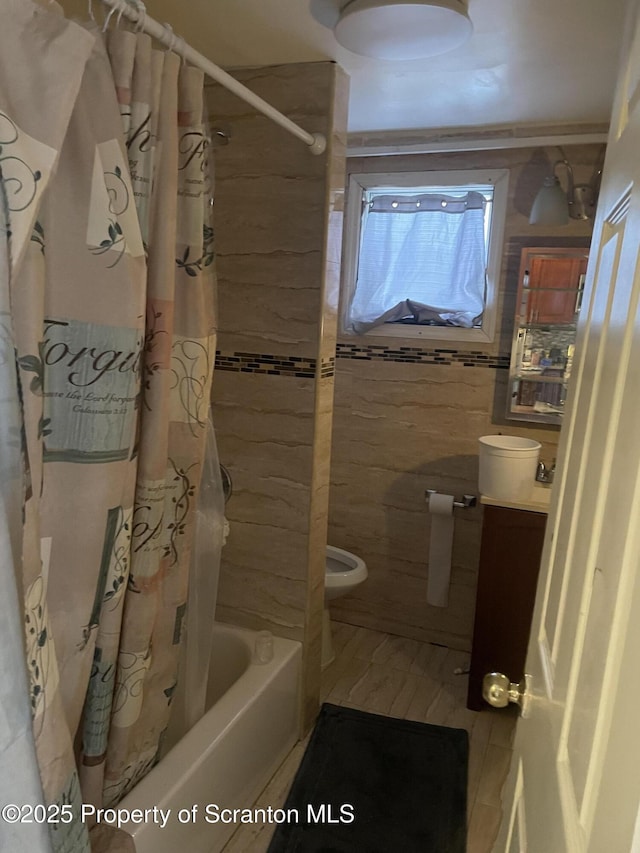 bathroom with shower / tub combo with curtain and toilet