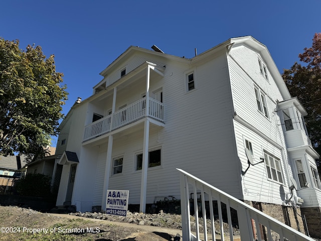 view of home's exterior with a balcony