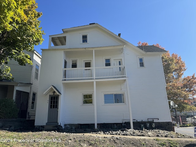 back of property featuring a balcony