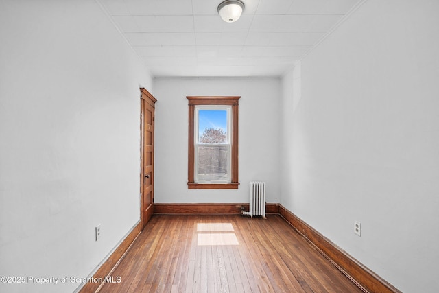 50 Harlem Ave, Carbondale, PA 18407 - unfurnished room with radiator heating unit, wood-type flooring, and baseboards