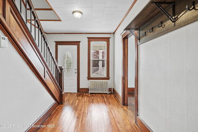 50 Harlem Ave, Carbondale, PA 18407 - entryway with radiator, stairs, light wood-style floors, baseboards, and ornamental molding