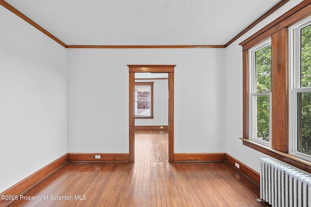 50 Harlem Ave, Carbondale, PA 18407 - empty room with radiator, crown molding, hardwood / wood-style flooring, and baseboards