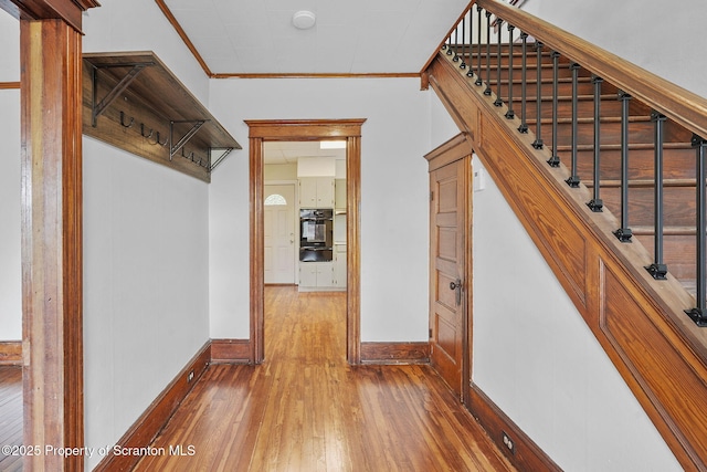 50 Harlem Ave, Carbondale, PA 18407 - staircase featuring baseboards, wood-type flooring, and crown molding