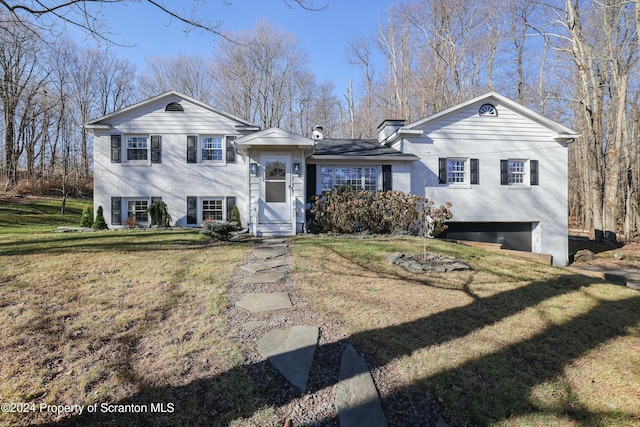 split level home with a front lawn