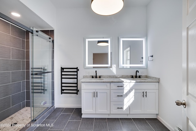 bathroom featuring vanity and a shower with shower door