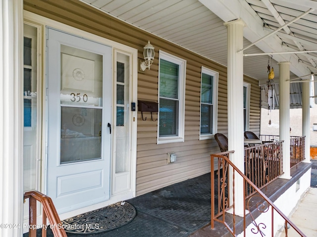 view of exterior entry featuring a porch