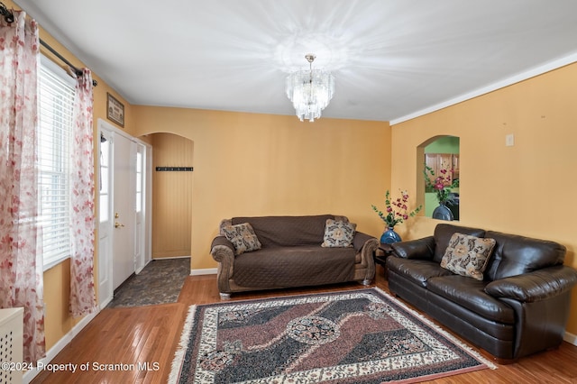 living room with hardwood / wood-style floors and a notable chandelier