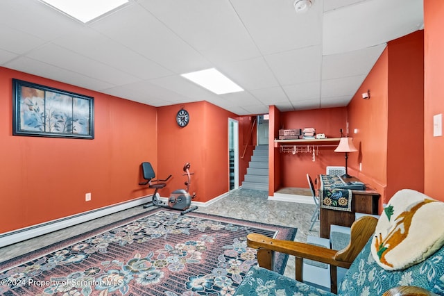 bedroom with a drop ceiling and a baseboard radiator