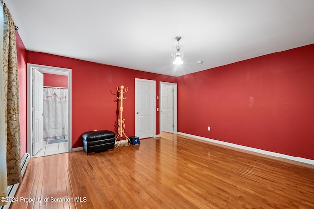 unfurnished room with hardwood / wood-style flooring