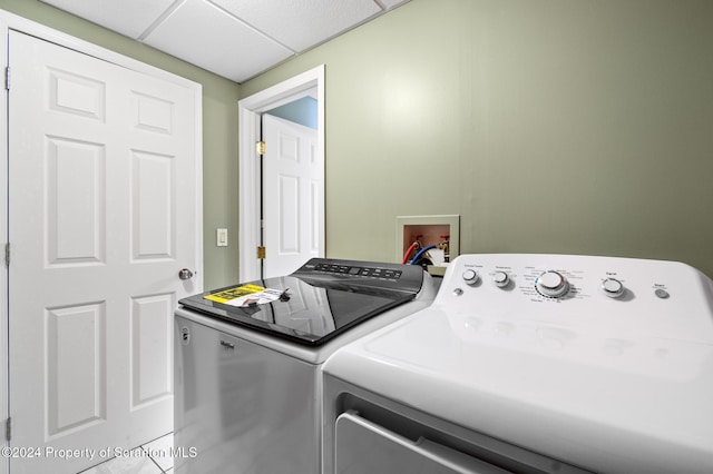 clothes washing area with separate washer and dryer