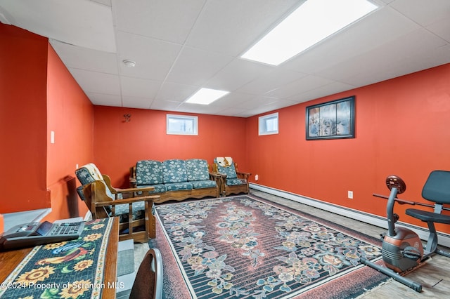 living room featuring a paneled ceiling and a baseboard radiator