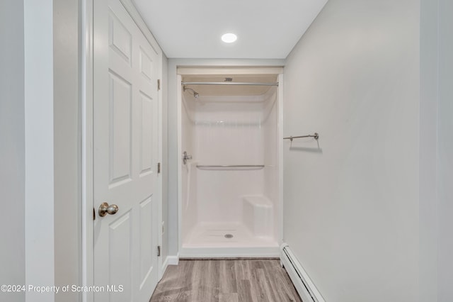 interior space featuring light wood-type flooring and a baseboard heating unit