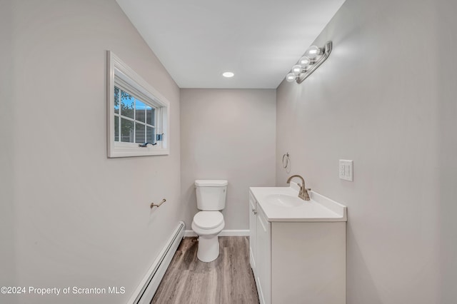 bathroom featuring hardwood / wood-style floors, vanity, toilet, and a baseboard radiator