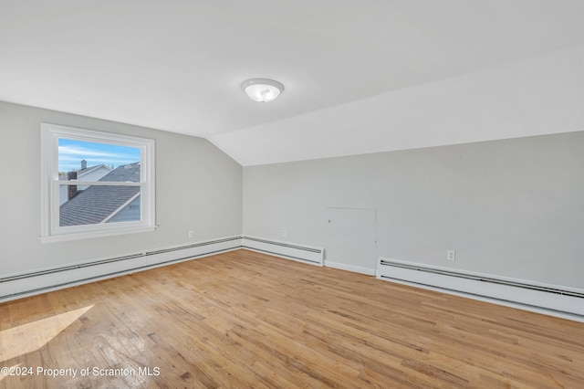 bonus room featuring light wood-type flooring, baseboard heating, and lofted ceiling