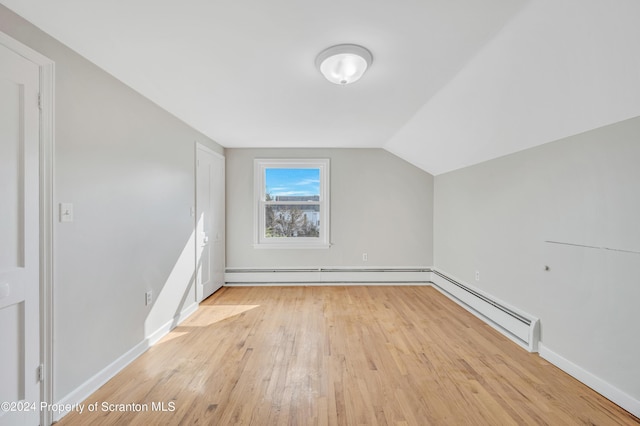 bonus room featuring vaulted ceiling, light hardwood / wood-style flooring, and baseboard heating