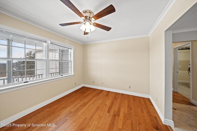 unfurnished room with ornamental molding, a ceiling fan, light wood-style flooring, and baseboards