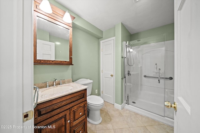 bathroom with vanity, tile patterned flooring, toilet, and a shower stall