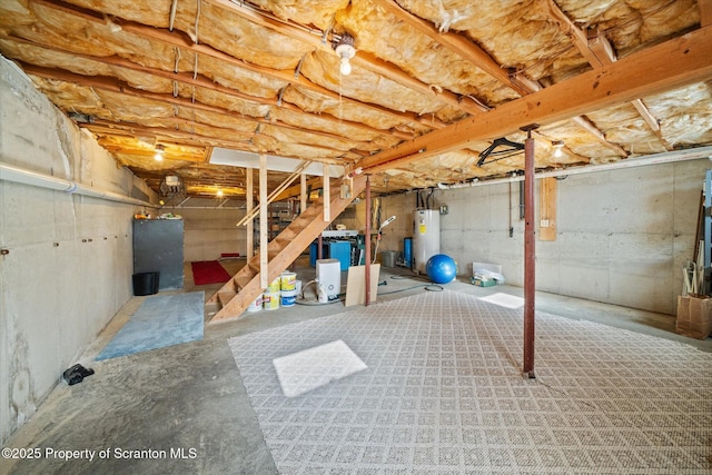 unfinished basement featuring water heater and stairway