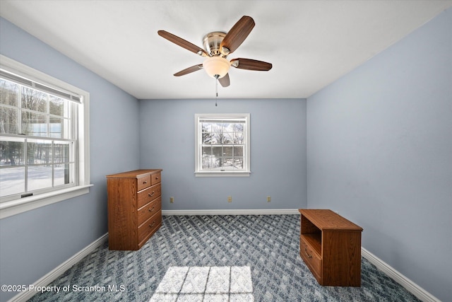 bedroom with ceiling fan, baseboards, and dark colored carpet