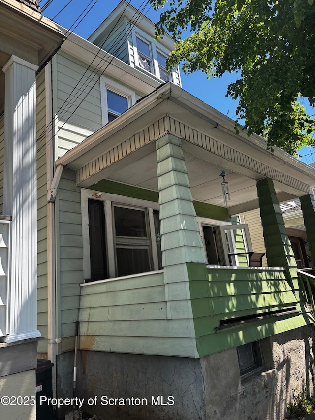 view of side of property featuring a porch