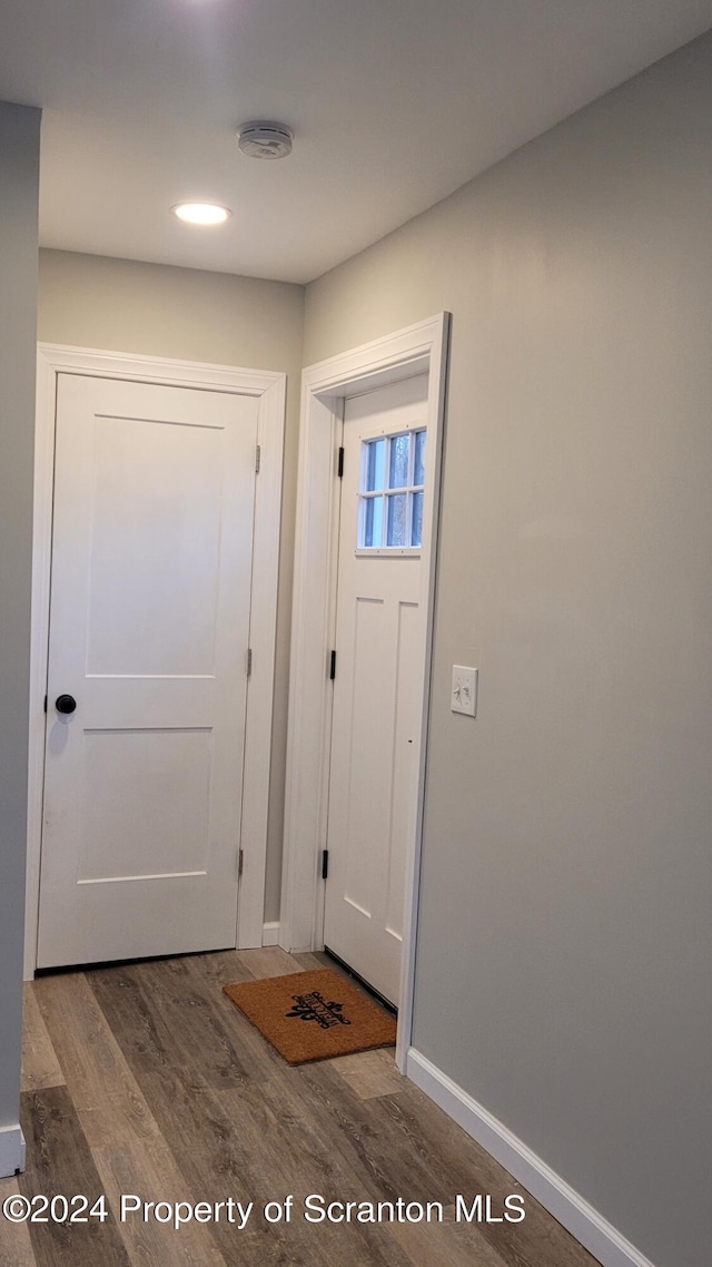 entryway with dark hardwood / wood-style flooring