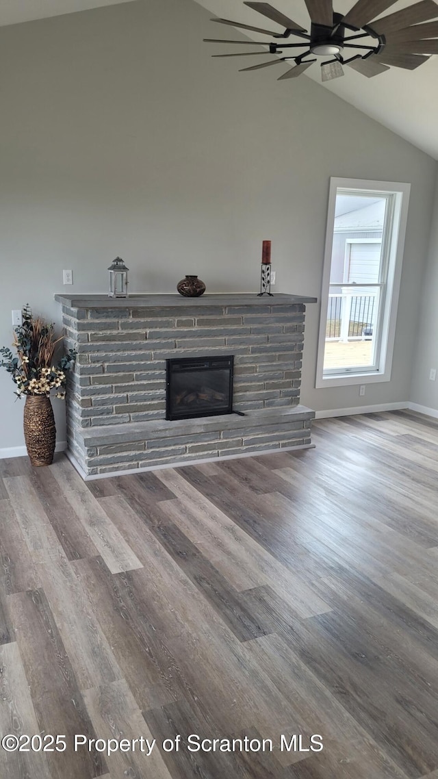 unfurnished living room with ceiling fan, vaulted ceiling, and hardwood / wood-style flooring