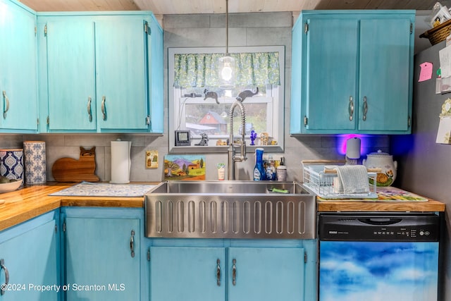 kitchen featuring dishwashing machine, tasteful backsplash, hanging light fixtures, and sink