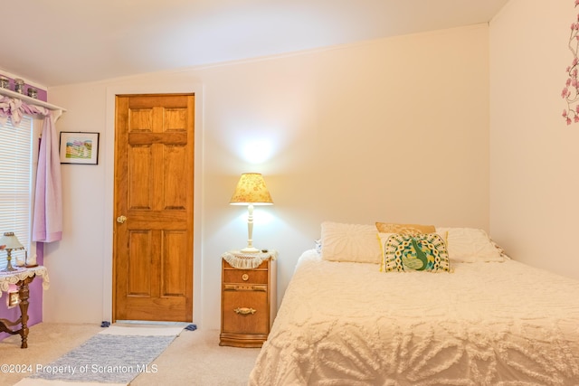 bedroom with light carpet and vaulted ceiling