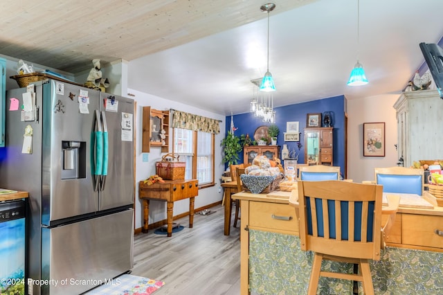 dining space with vaulted ceiling, light wood-type flooring, and wooden ceiling