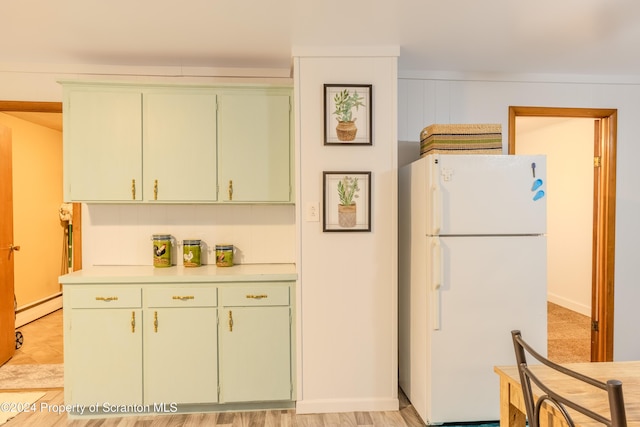 kitchen featuring white refrigerator, light wood-type flooring, and a baseboard radiator