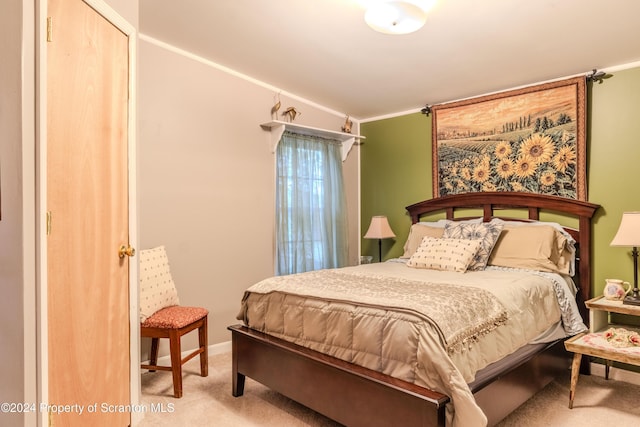 bedroom featuring light carpet and ornamental molding