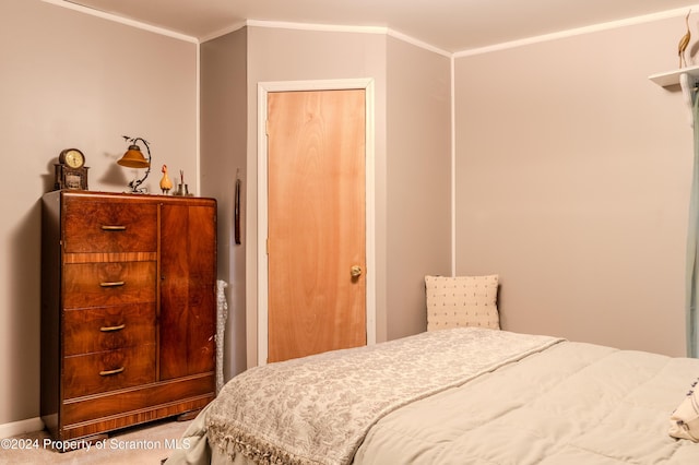 bedroom with carpet and crown molding