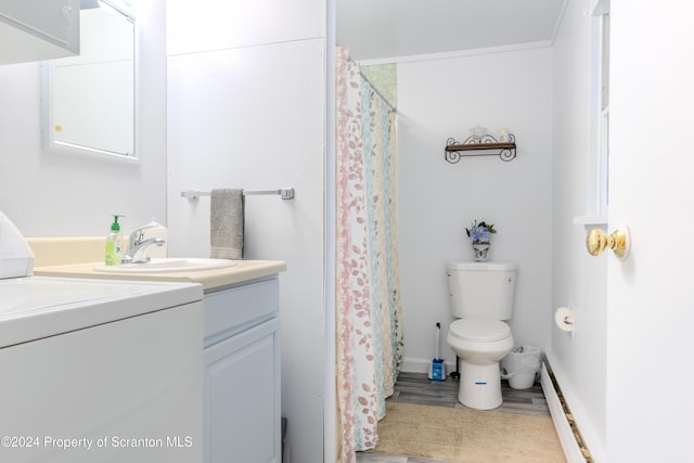 bathroom featuring vanity, toilet, baseboard heating, wood-type flooring, and washer / clothes dryer