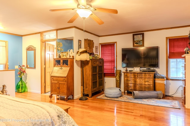 bedroom with ceiling fan, ornamental molding, and light wood-type flooring