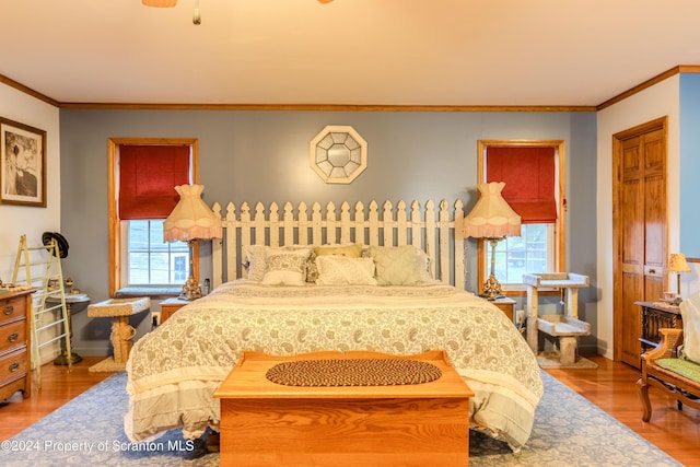 bedroom featuring hardwood / wood-style floors and ornamental molding