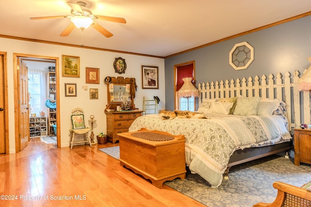 bedroom featuring hardwood / wood-style floors, ceiling fan, and crown molding