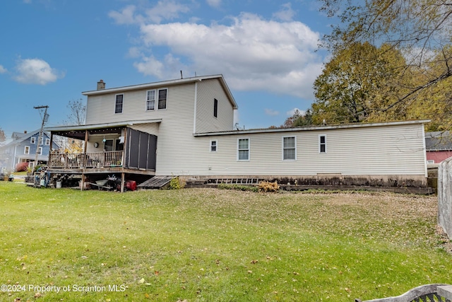 back of house with a sunroom and a yard