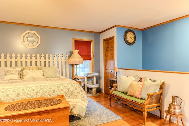 bedroom featuring crown molding and hardwood / wood-style floors