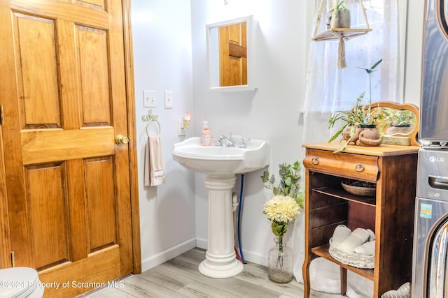 bathroom with hardwood / wood-style floors and toilet