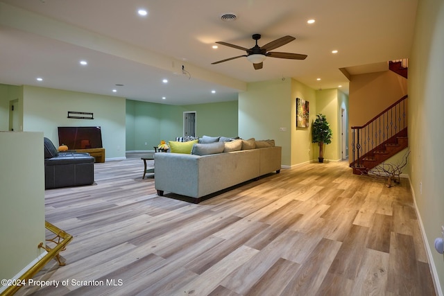 living room featuring ceiling fan and light wood-type flooring